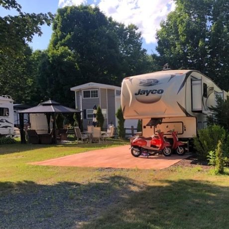 rv parked on paved lot with grass